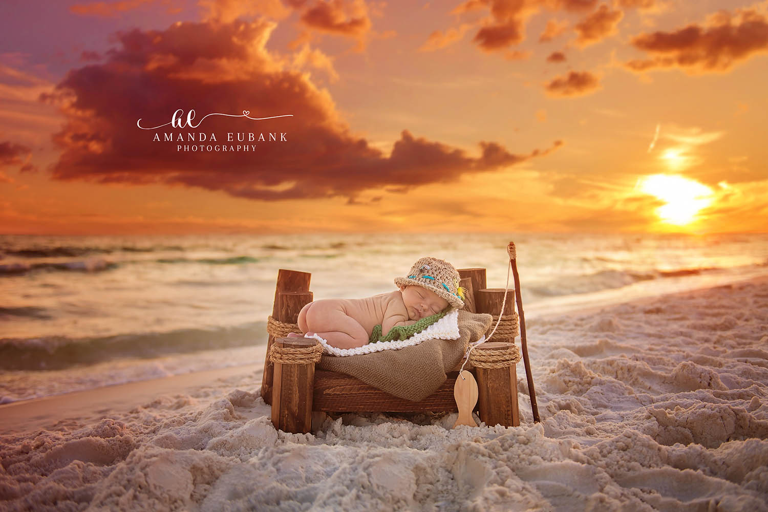 Destin Newborn Photographer | Beach Fisherman Newborn Session Destin newborn photographer captures sleeping baby in a tiny fisherman hat in a wooden basket on the white sand beach in Destin, Florida.